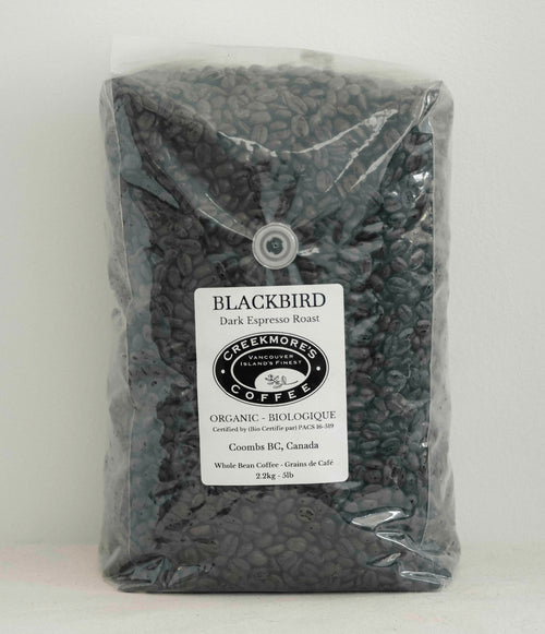 A 3 lb bag of Creekmore Coffee Blackbird Dark Espresso Roast whole bean coffee in a clear plastic bag with a white label.
