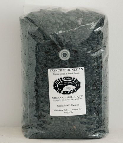 A 2.25 kg (5 lb) bag of Creekmore's Coffee French Indonesian Organic Dark Roast whole bean coffee in a clear plastic bag with a white label.