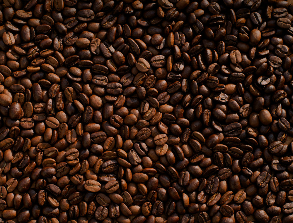 Close-up of coffee beans with a dark brown color.